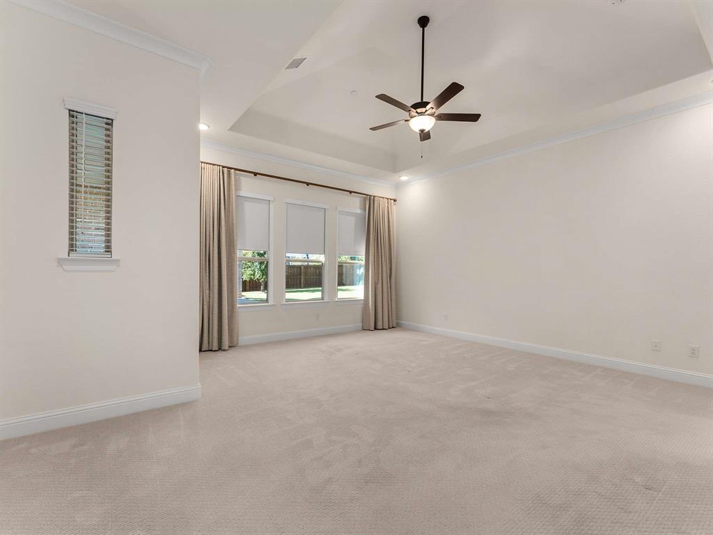 910 Marie Drive Allen, TX 75013 - Photo 16 of 38 an empty room with chandelier fan and windows