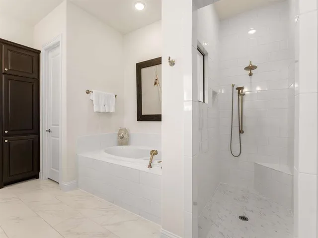 a bathroom with a shower a mirror and a sink