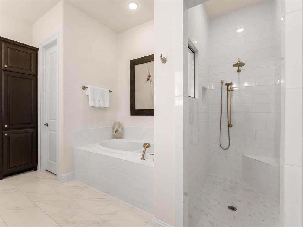 910 Marie Drive Allen, TX 75013 - Photo 19 of 38 a bathroom with a shower a mirror and a sink