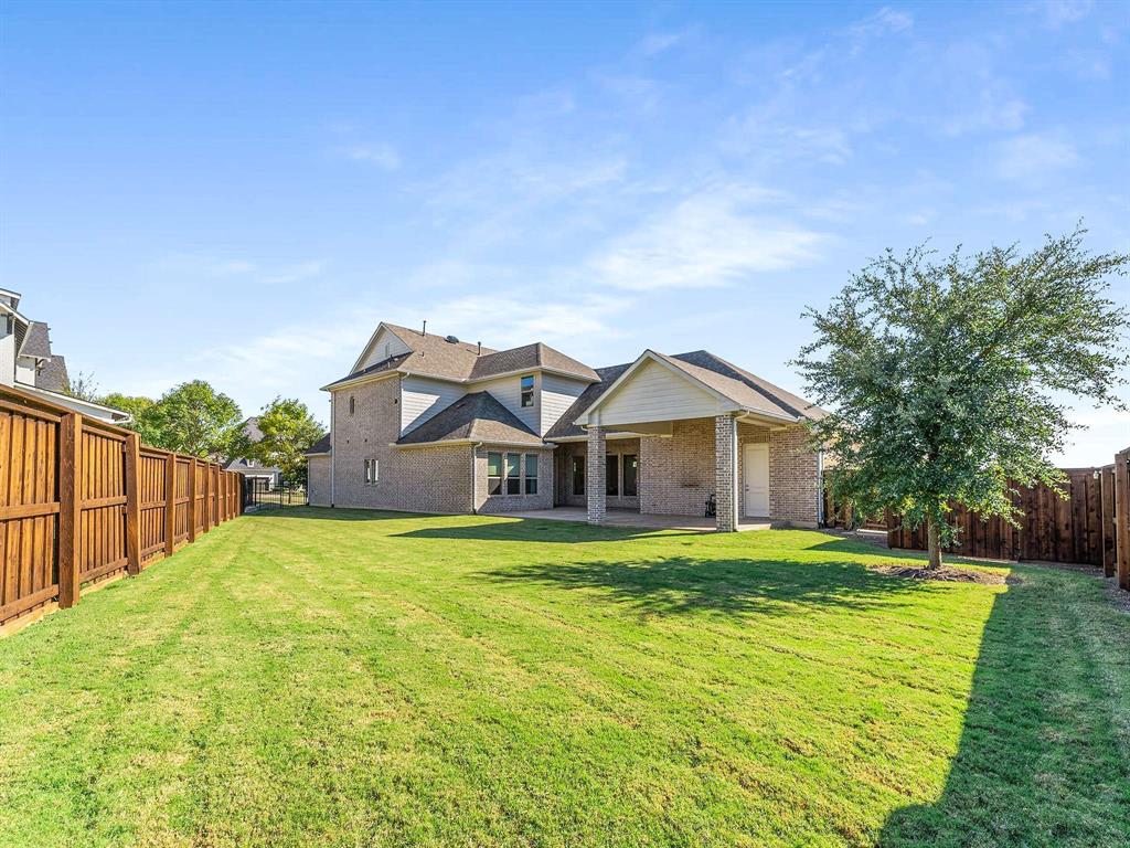 910 Marie Drive Allen, TX 75013 - Photo 2 of 38 a big house with a big yard and large trees
