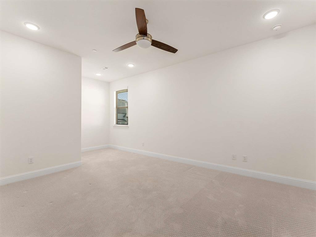910 Marie Drive Allen, TX 75013 - Photo 28 of 38 an empty room with a ceiling fan and window