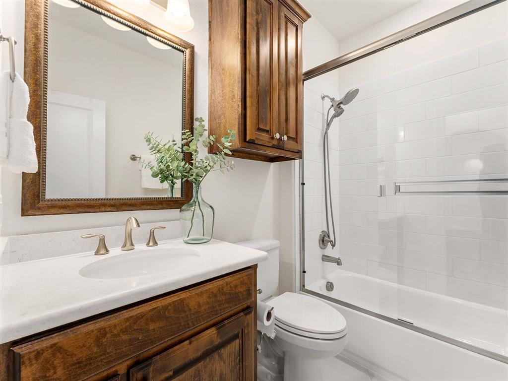 910 Marie Drive Allen, TX 75013 - Photo 29 of 38 a bathroom with a granite countertop sink toilet and shower