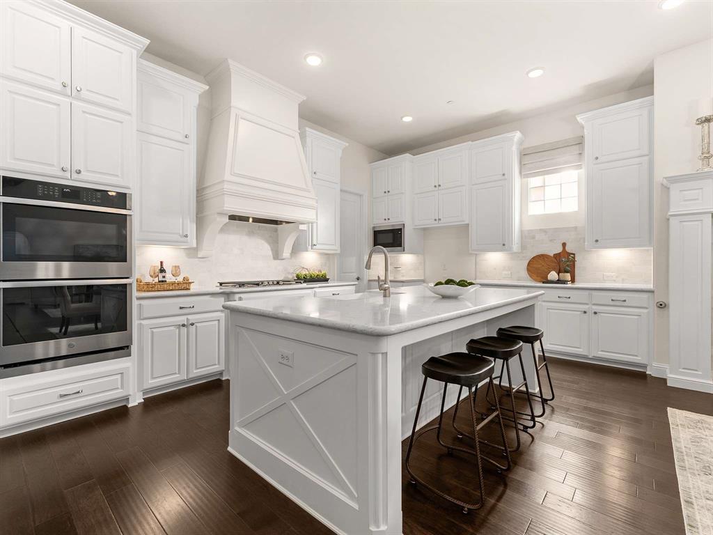 910 Marie Drive Allen, TX 75013 - Photo 3 of 38 a kitchen with stainless steel appliances a stove a sink and a microwave
