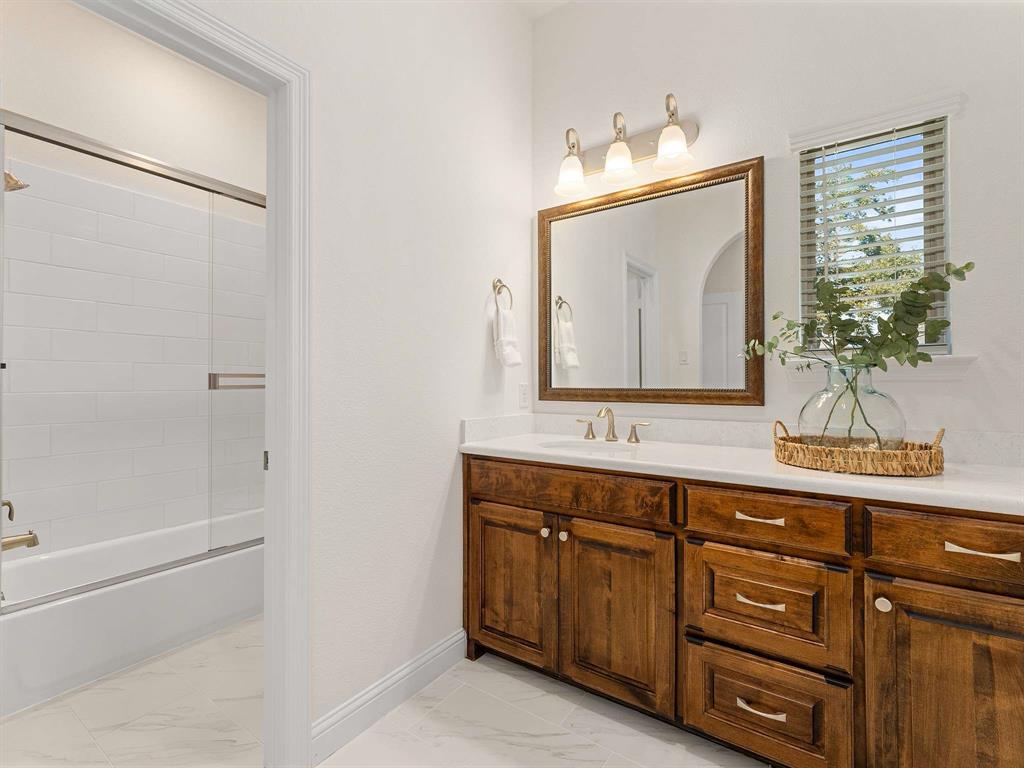 910 Marie Drive Allen, TX 75013 - Photo 31 of 38 a bathroom with a sink and a mirror
