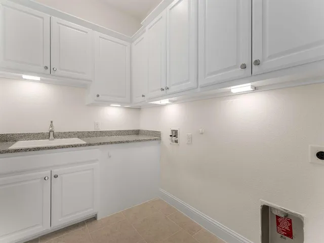 a kitchen with white cabinets and a sink
