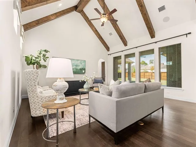 a living room with furniture and wooden floor