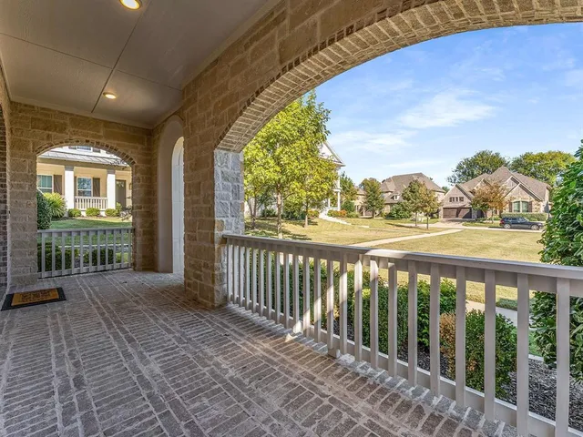 a view of a porch with wooden floor and fence