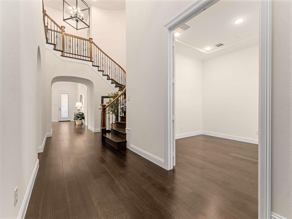 910 Marie Drive Allen, TX 75013 - Photo 6 of 38 a view of a hallway view with wooden floor and staircase