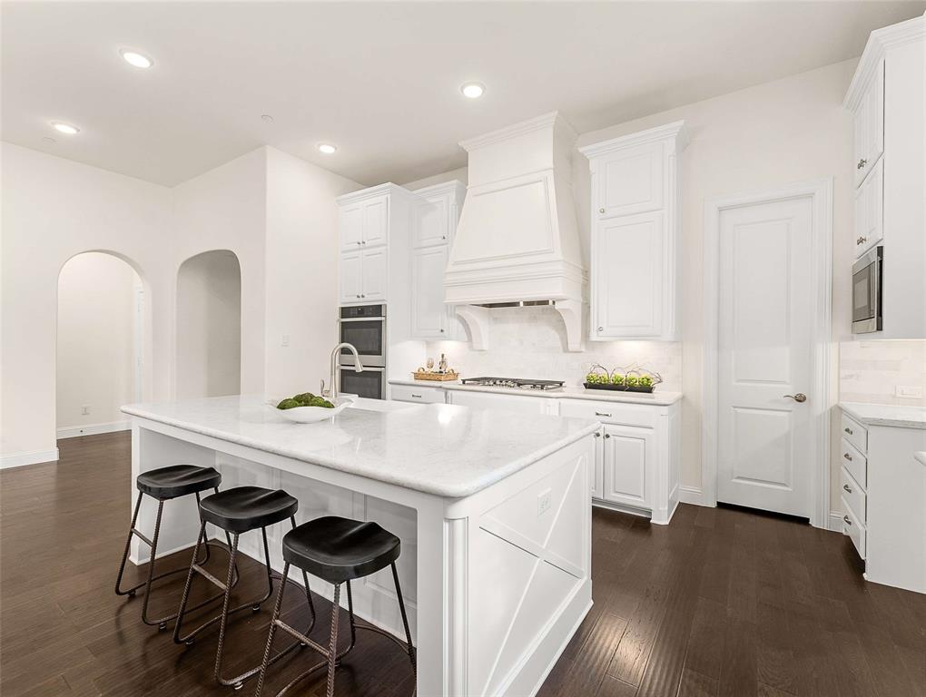 910 Marie Drive Allen, TX 75013 - Photo 10 of 38 a kitchen with white cabinets and appliances