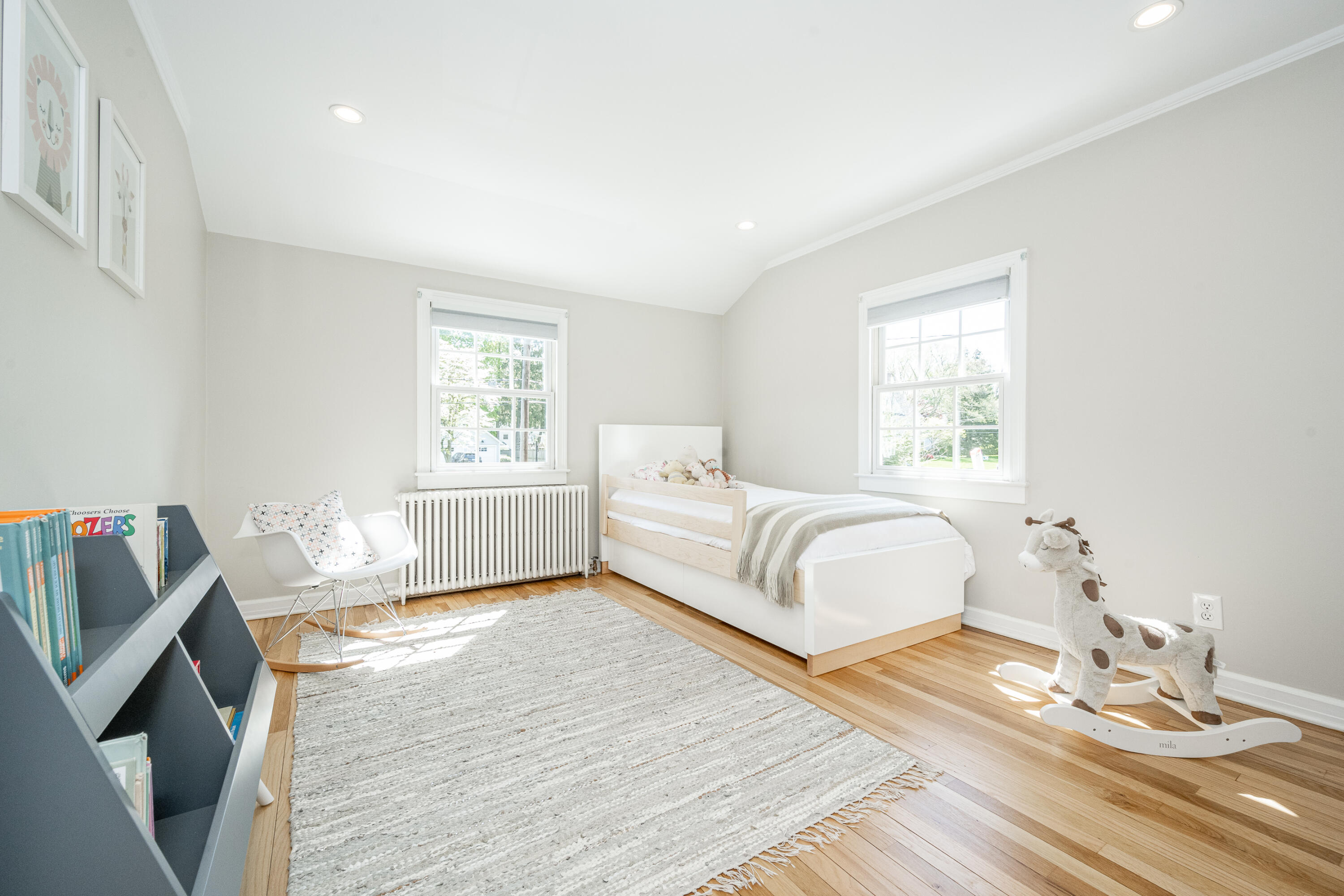 35 Miles Road Darien, CT 06820 - Photo 20 of 29 a spacious bedroom with a bed a couch and wooden floor
