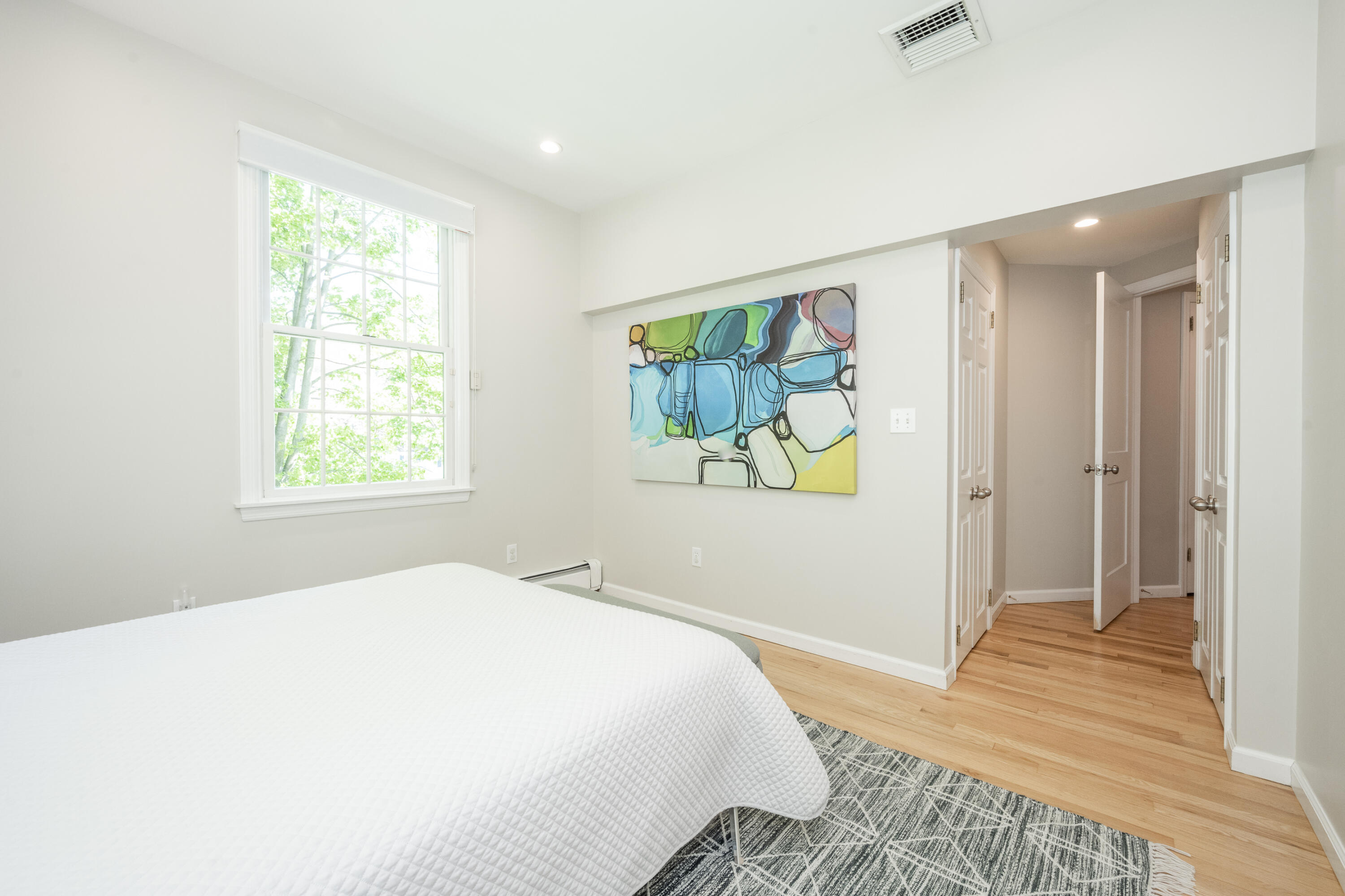 35 Miles Road Darien, CT 06820 - Photo 24 of 29 a bedroom with a bed and a painting on the wall