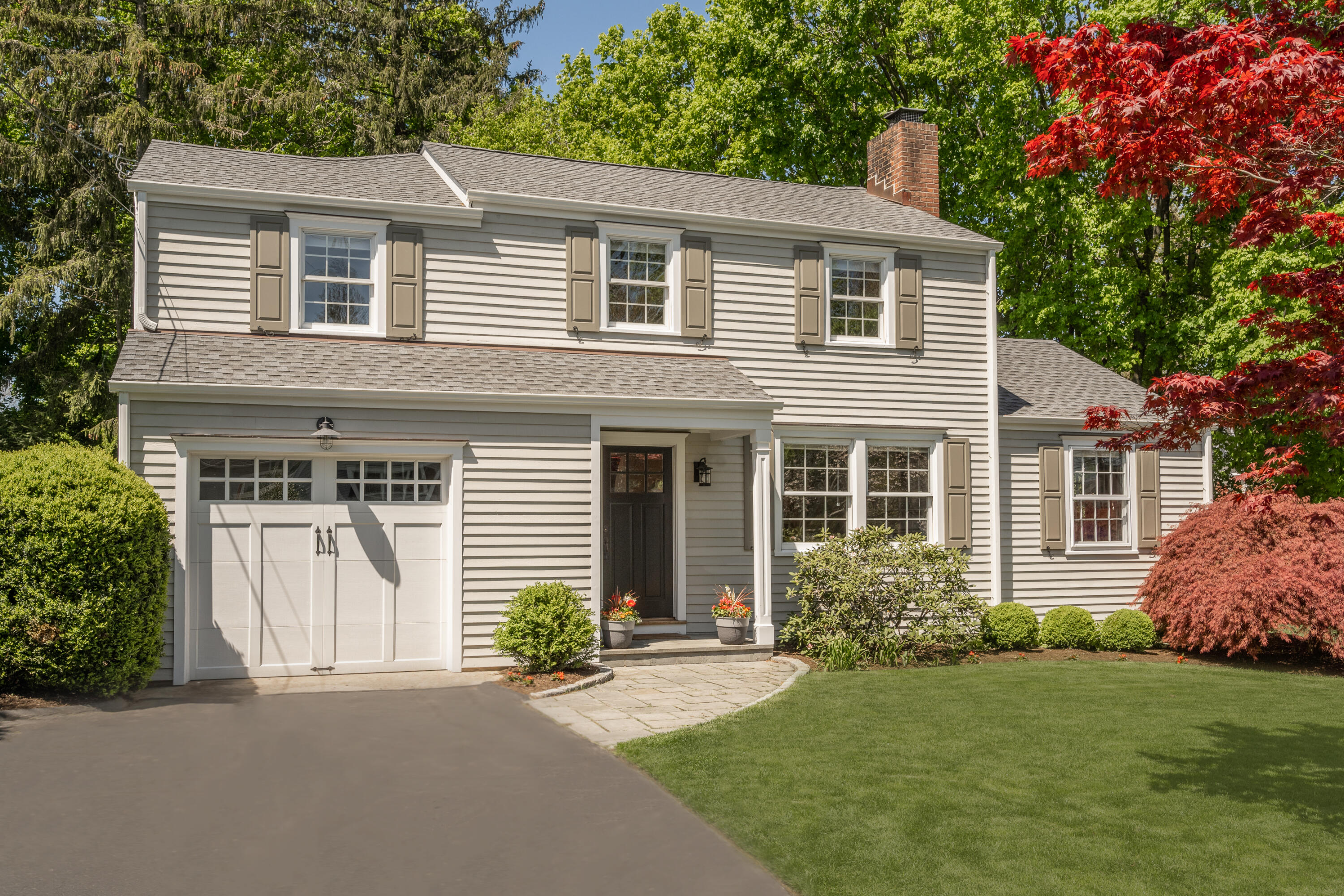 35 Miles Road Darien, CT 06820 - Photo 5 of 29 front view of a house with a yard and a trees