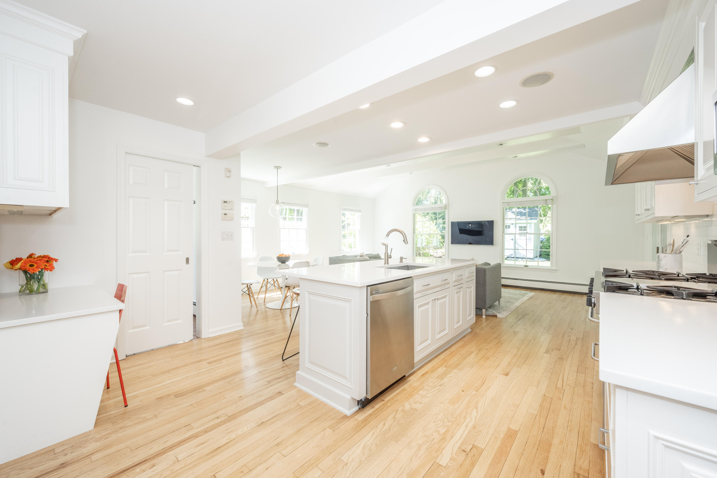 35 Miles Road Darien, CT 06820 - Photo 10 of 29 a large white kitchen with wooden floors and stainless steel appliances