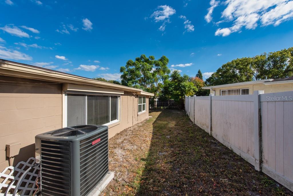 5117 School Road New Port Richey, FL 34653 - Photo 20 of 24 a backyard of a house with lots of green space