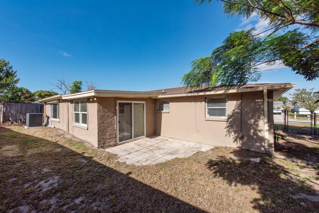 5117 School Road New Port Richey, FL 34653 - Photo 23 of 24 a front view of a house with a yard