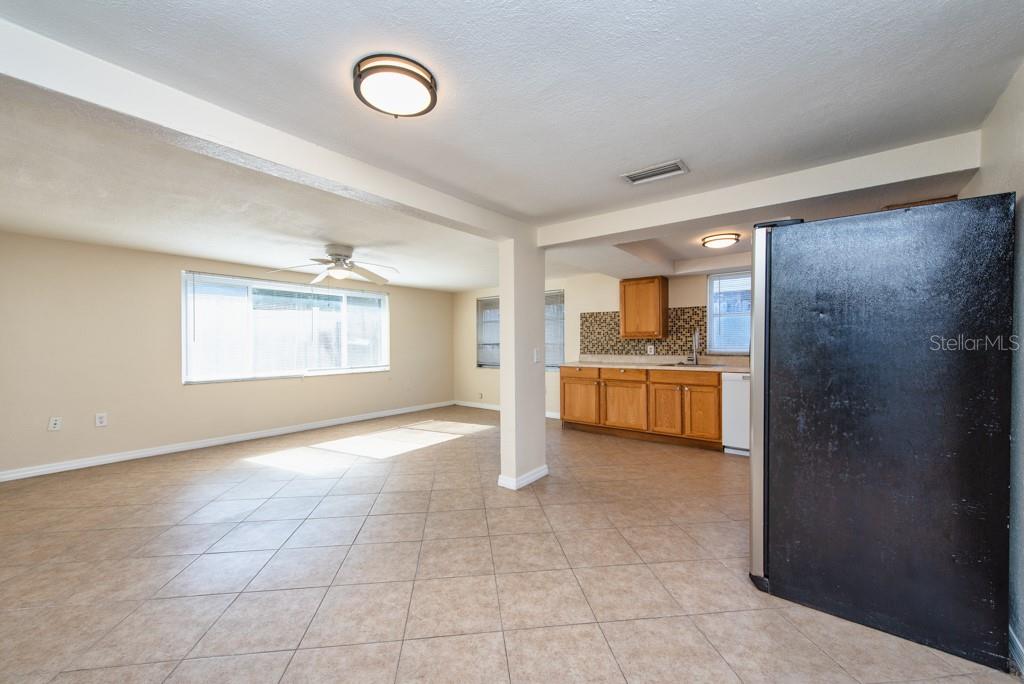 5117 School Road New Port Richey, FL 34653 - Photo 8 of 24 a view of a kitchen with a sink and a refrigerator