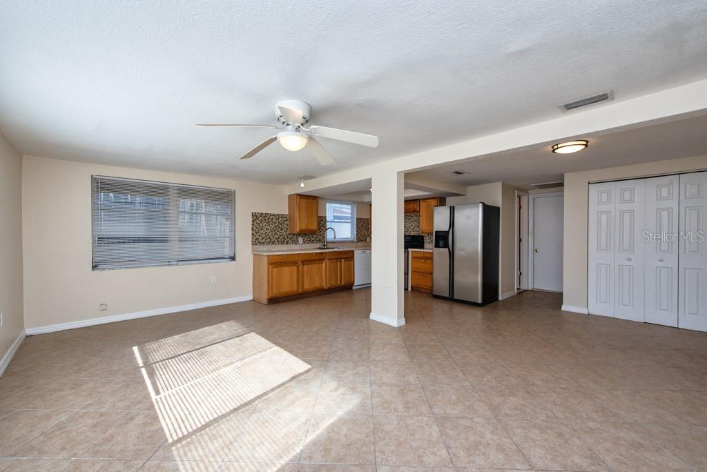 5117 School Road New Port Richey, FL 34653 - Photo 9 of 24 a view of a livingroom with a kitchen and a window