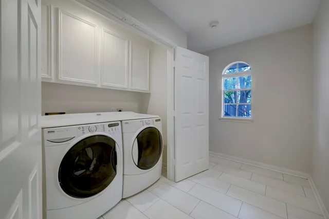 a bathroom with a sink a toilet and a large mirror