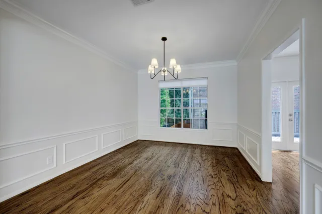 a view of an empty room with a fireplace and a window
