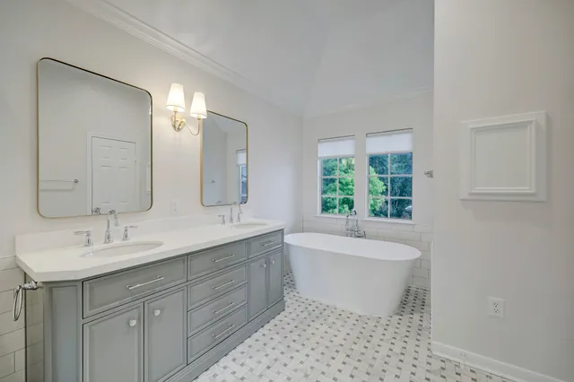 a bathroom with a bathtub a toilet a sink and shower