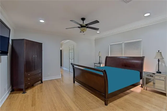 a bedroom with a bed and a chandelier