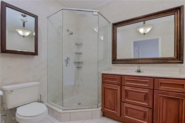 a bathroom with a toilet a sink and shower