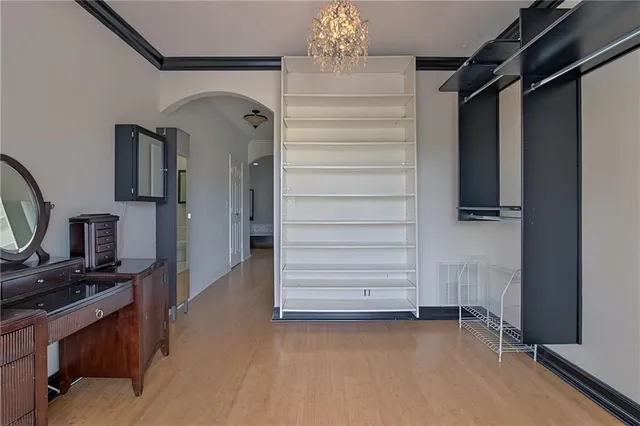 a view of hallway with stairs and wooden floor