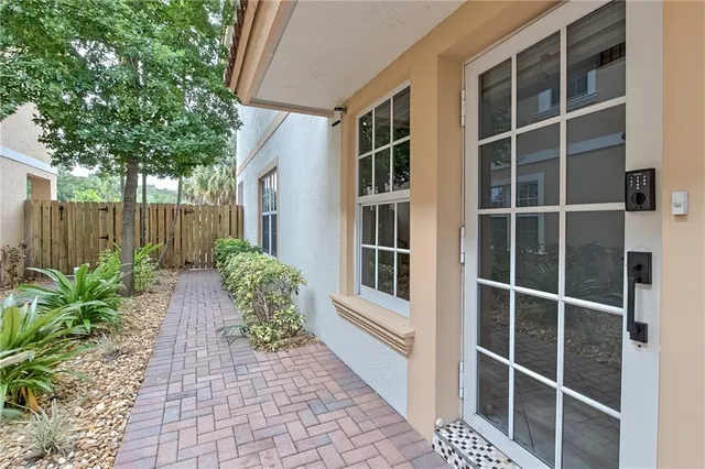 a house with potted plants in front of door