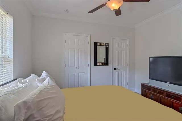 a bedroom with a bed and a flat screen tv