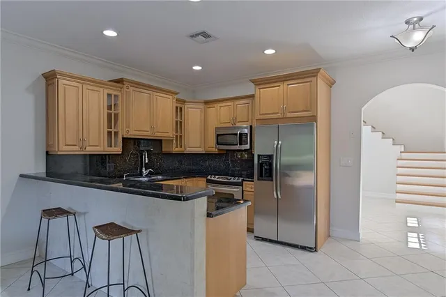 a kitchen with a refrigerator a sink and cabinets