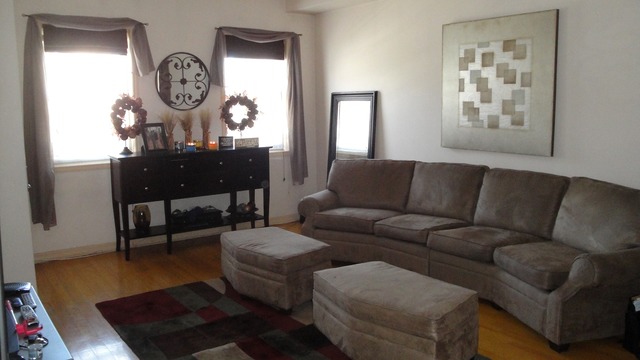 2807 West Jackson Boulevard, Unit 2 Chicago, IL 60612 - Photo 2 of 13 a living room with furniture a clock on wall and a window