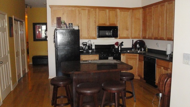 2807 West Jackson Boulevard, Unit 2 Chicago, IL 60612 - Photo 4 of 13 a kitchen with a refrigerator and a stove top oven