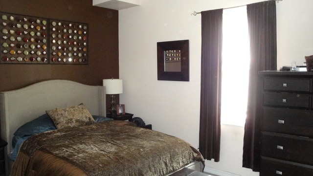 2807 West Jackson Boulevard, Unit 2 Chicago, IL 60612 - Photo 10 of 13 a bedroom with a bed and a painting on the wall