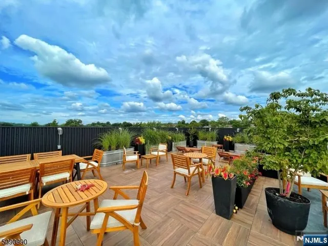 a view of a terrace with furniture and a stove