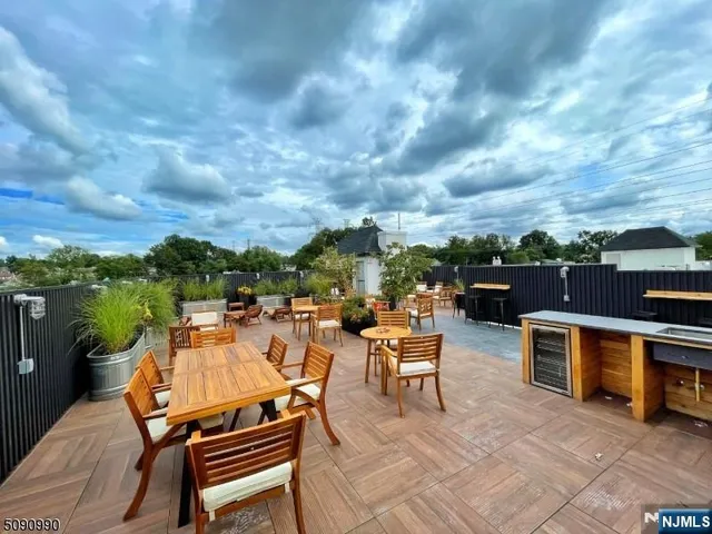 a view of a terrace with couches and lounge chairs