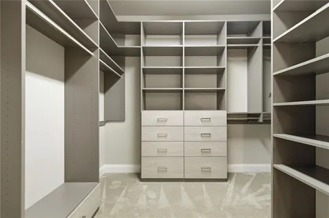 a view of walk in closet with empty racks