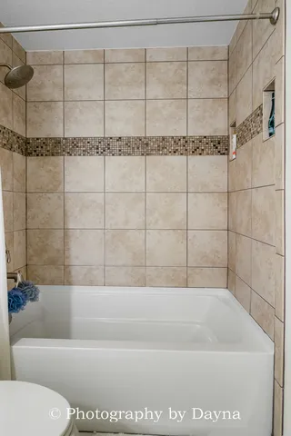 a bathroom with a granite countertop sink a toilet and mirror