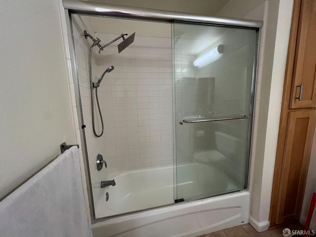 a bathroom with a glass shower door