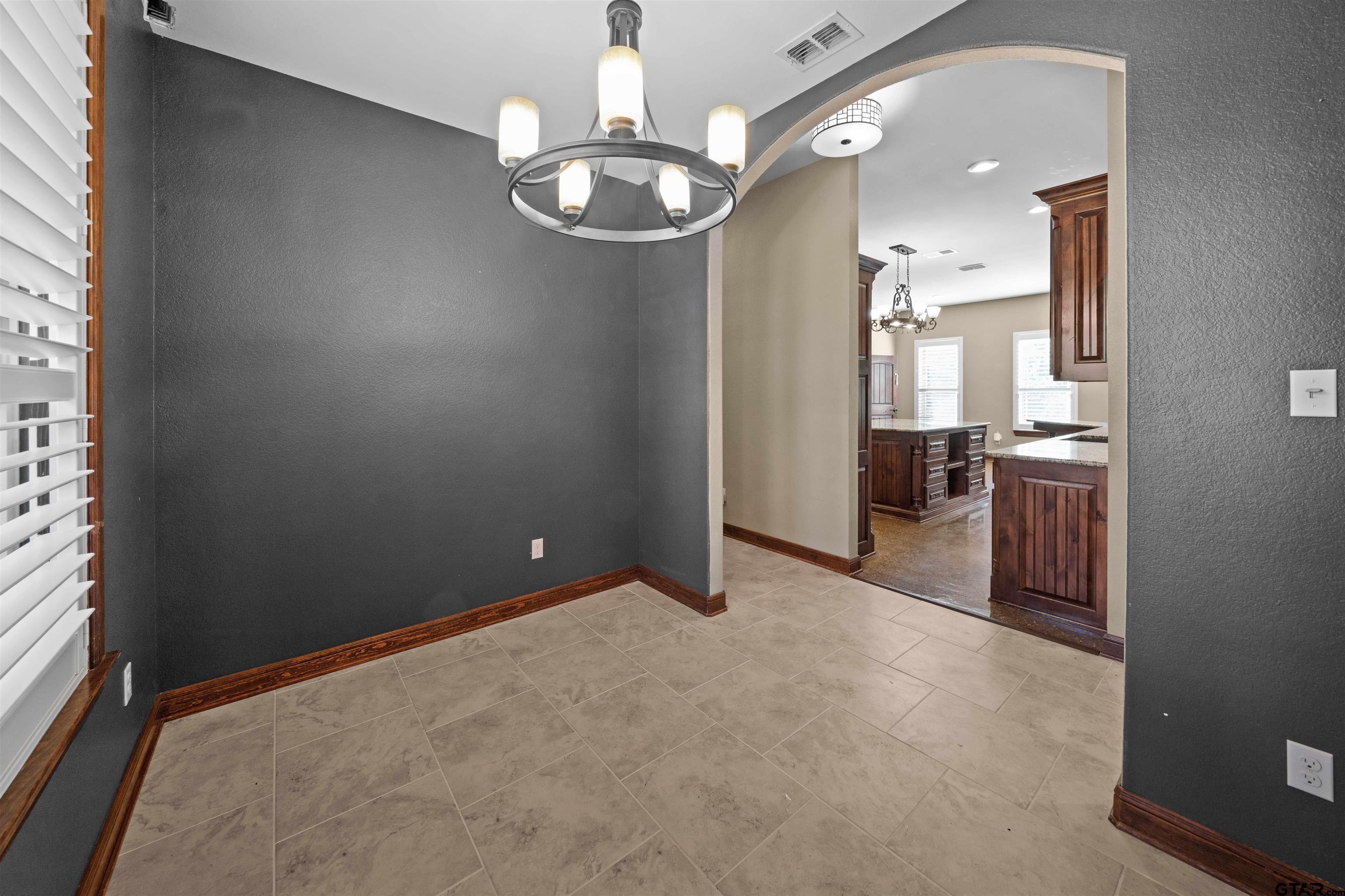 17153 County Road 1108 Flint, TX 75762 - Photo 13 of 45 en empty room with kitchen view and wooden floor