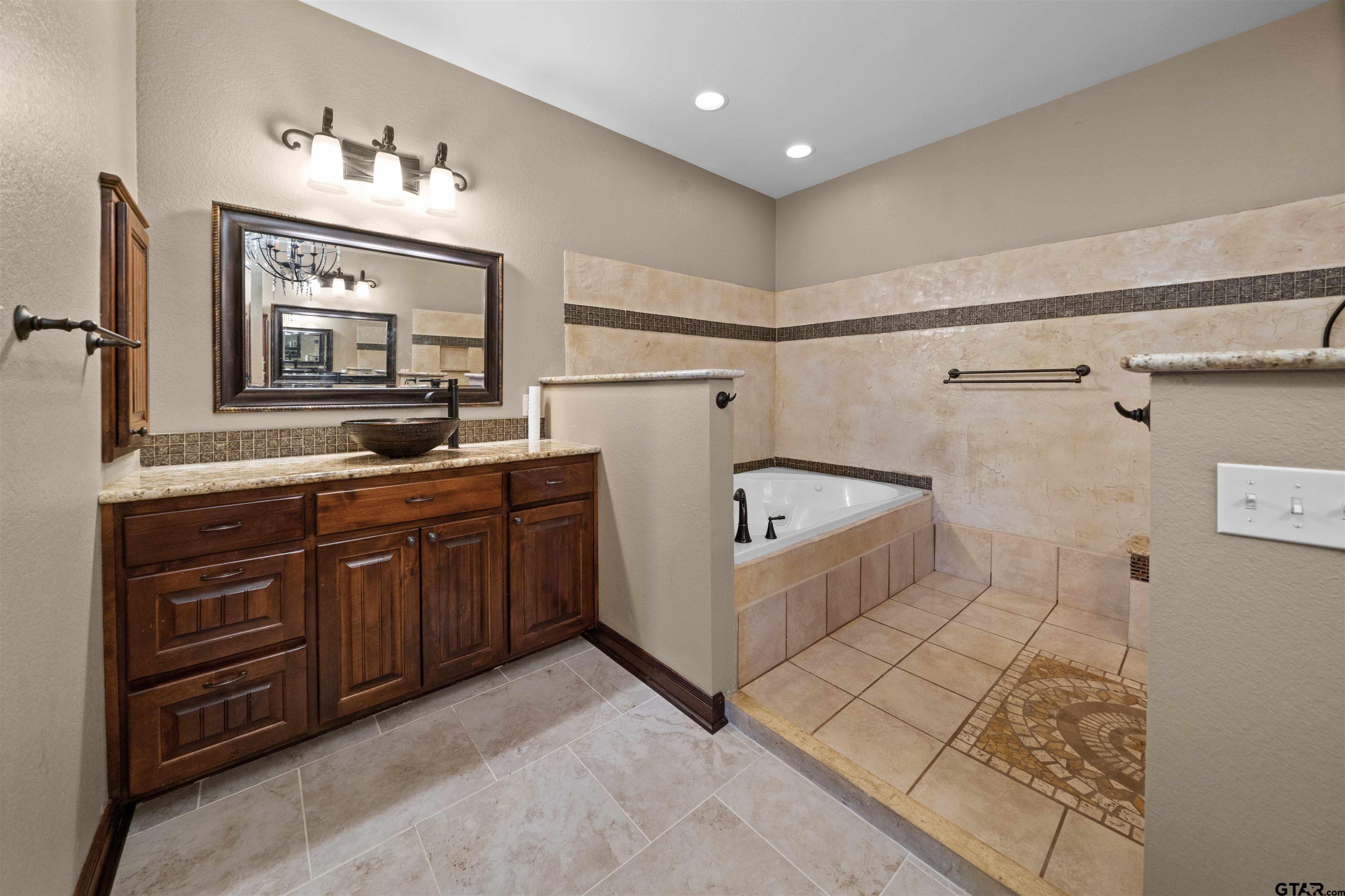 17153 County Road 1108 Flint, TX 75762 - Photo 22 of 45 a bathroom with a sink a bathtub and a mirror