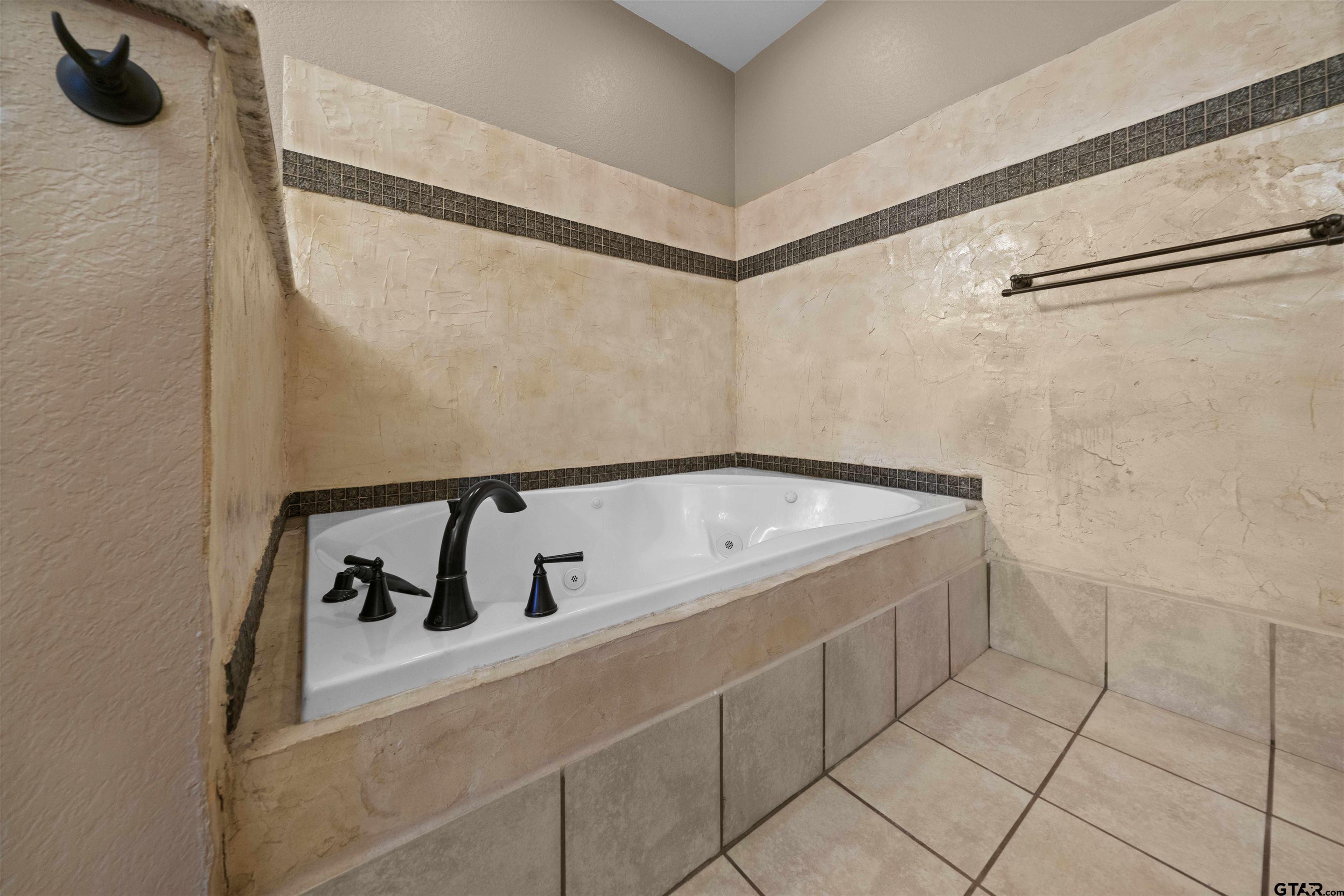 17153 County Road 1108 Flint, TX 75762 - Photo 25 of 45 a bath tub sitting next to a white sink and vanity