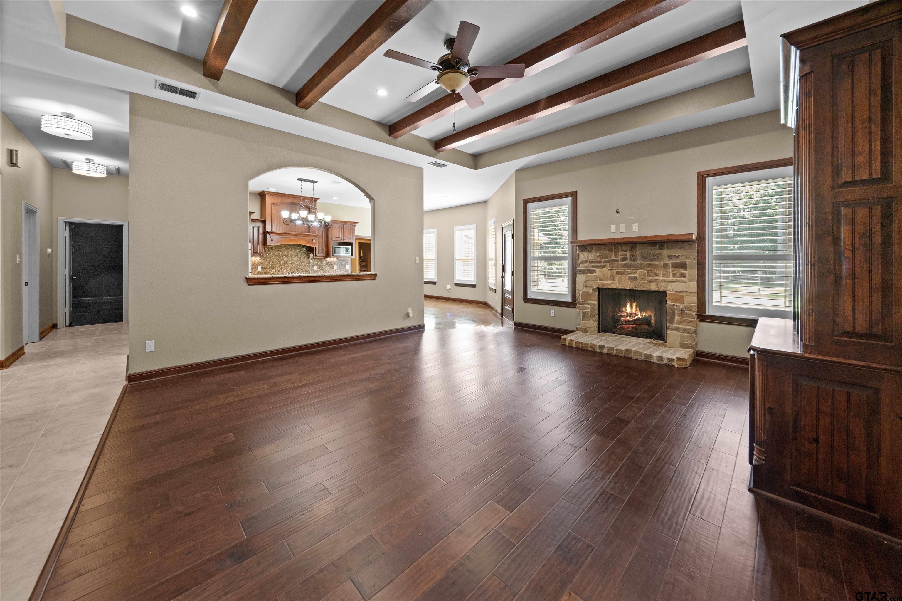 17153 County Road 1108 Flint, TX 75762 - Photo 3 of 45 an empty room with wooden floor fireplace and windows