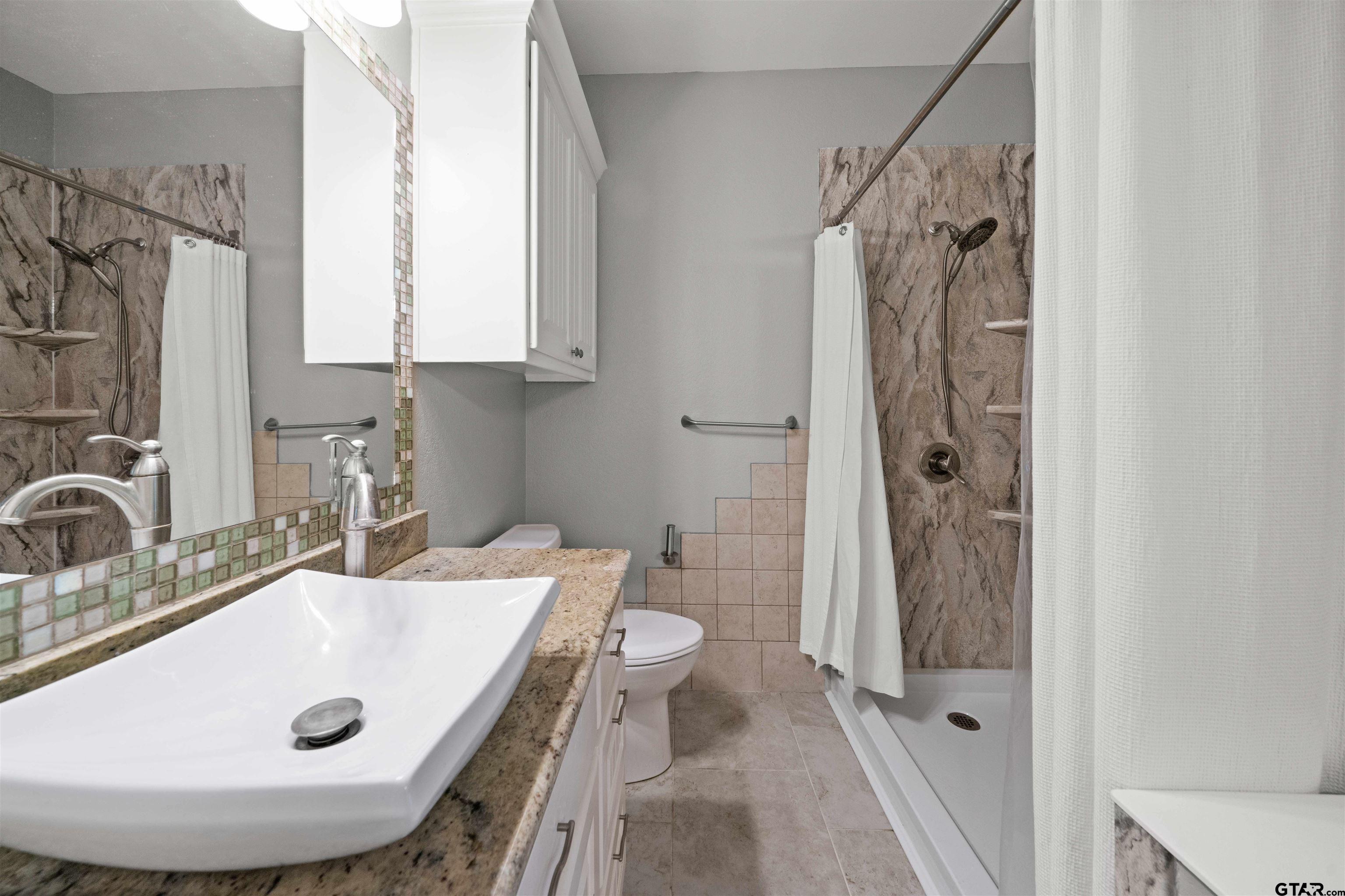17153 County Road 1108 Flint, TX 75762 - Photo 38 of 45 a bathroom with a sink toilet and shower