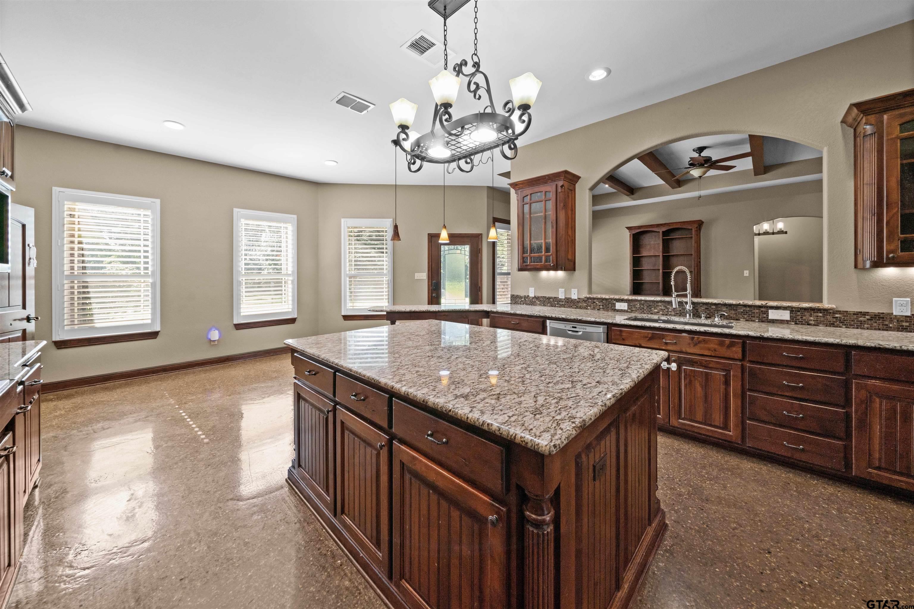 17153 County Road 1108 Flint, TX 75762 - Photo 7 of 45 a bathroom with a granite countertop sink a large mirror and a wooden floors