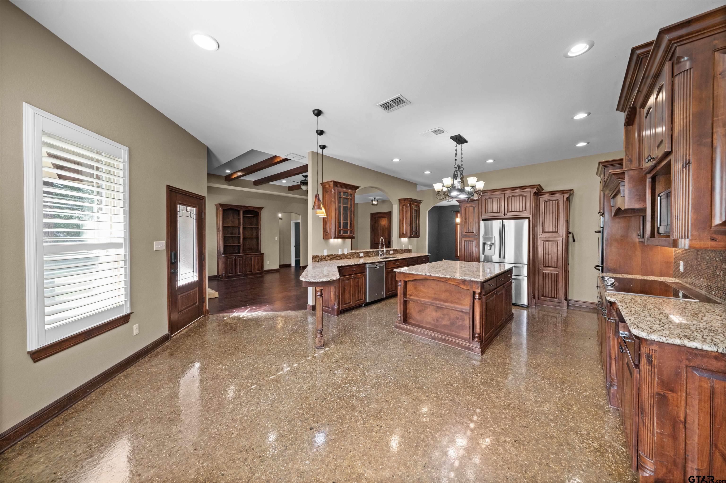 17153 County Road 1108 Flint, TX 75762 - Photo 9 of 45 a large living room with stainless steel appliances kitchen island granite countertop furniture and a large window