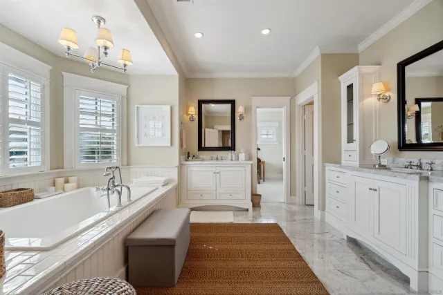 a spacious bathroom with a double vanity sink a mirror and a bathtub