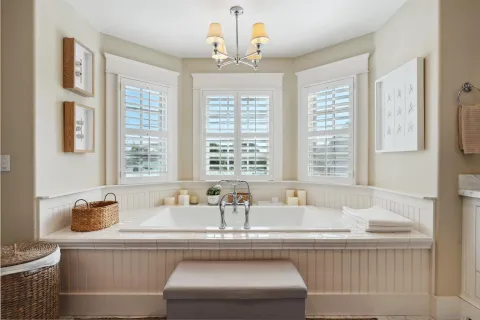 a living room with furniture and large windows