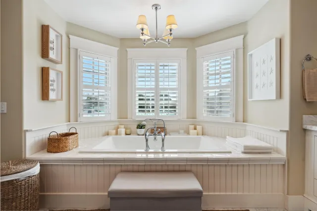 a living room with furniture and large windows