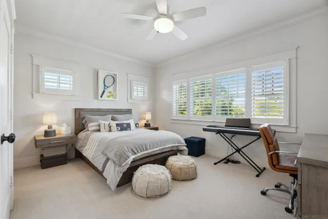 a bedroom with two beds and a large window