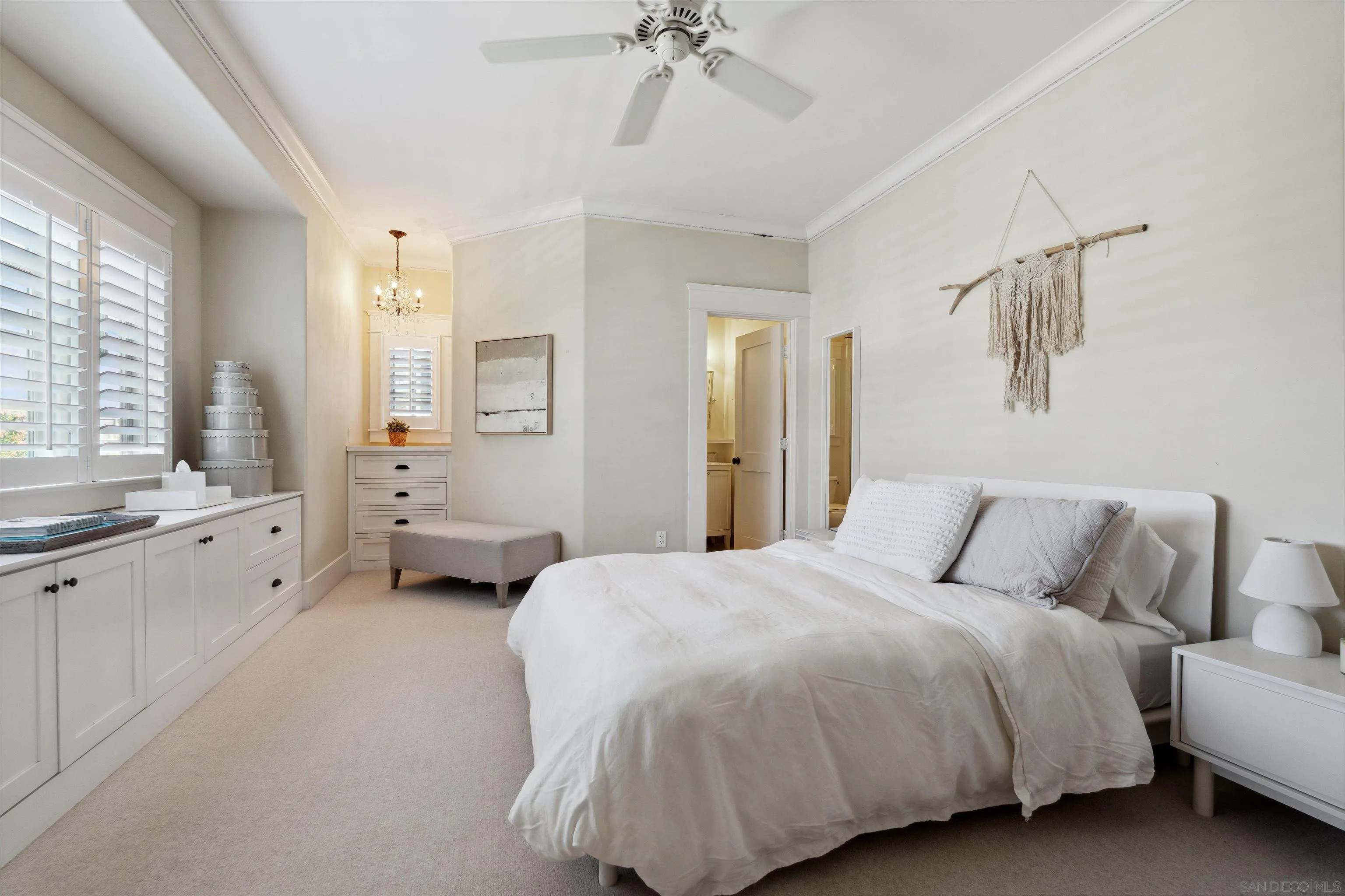 731 Balboa Avenue Coronado, CA 92118 - Photo 15 of 18 a spacious bedroom with a bed and a chandelier